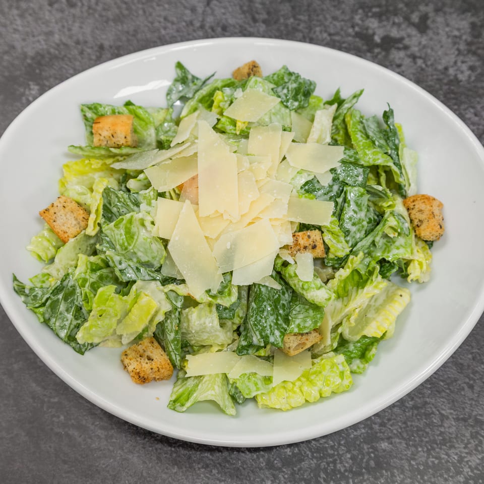 Classic Caesar salad with crisp romaine, creamy dressing, crunchy croutons, and shaved Parmesan.