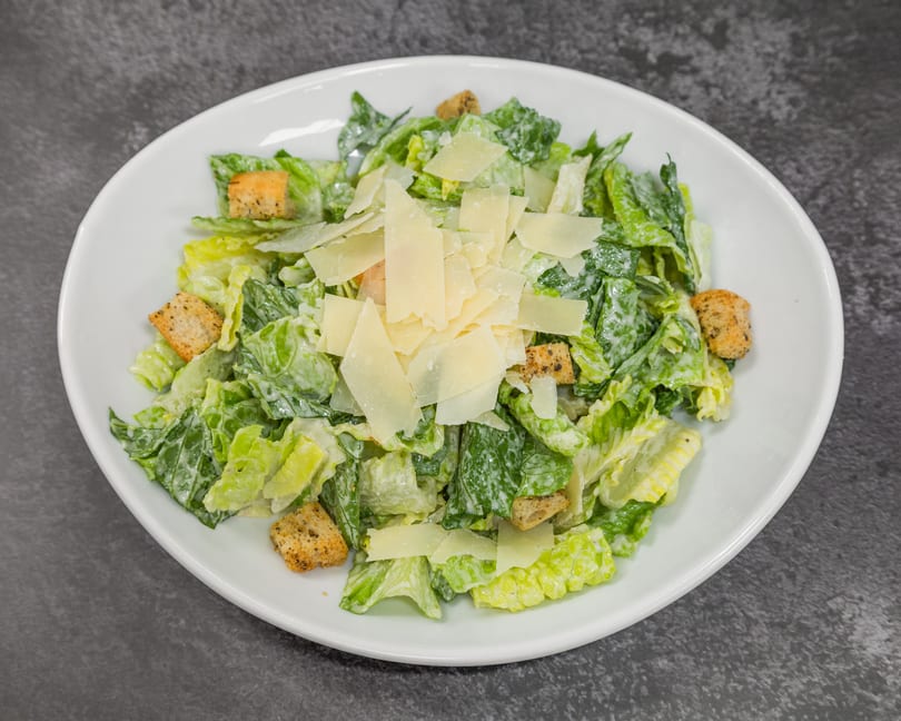 Classic Caesar salad with crisp romaine, creamy dressing, crunchy croutons, and shaved Parmesan.
